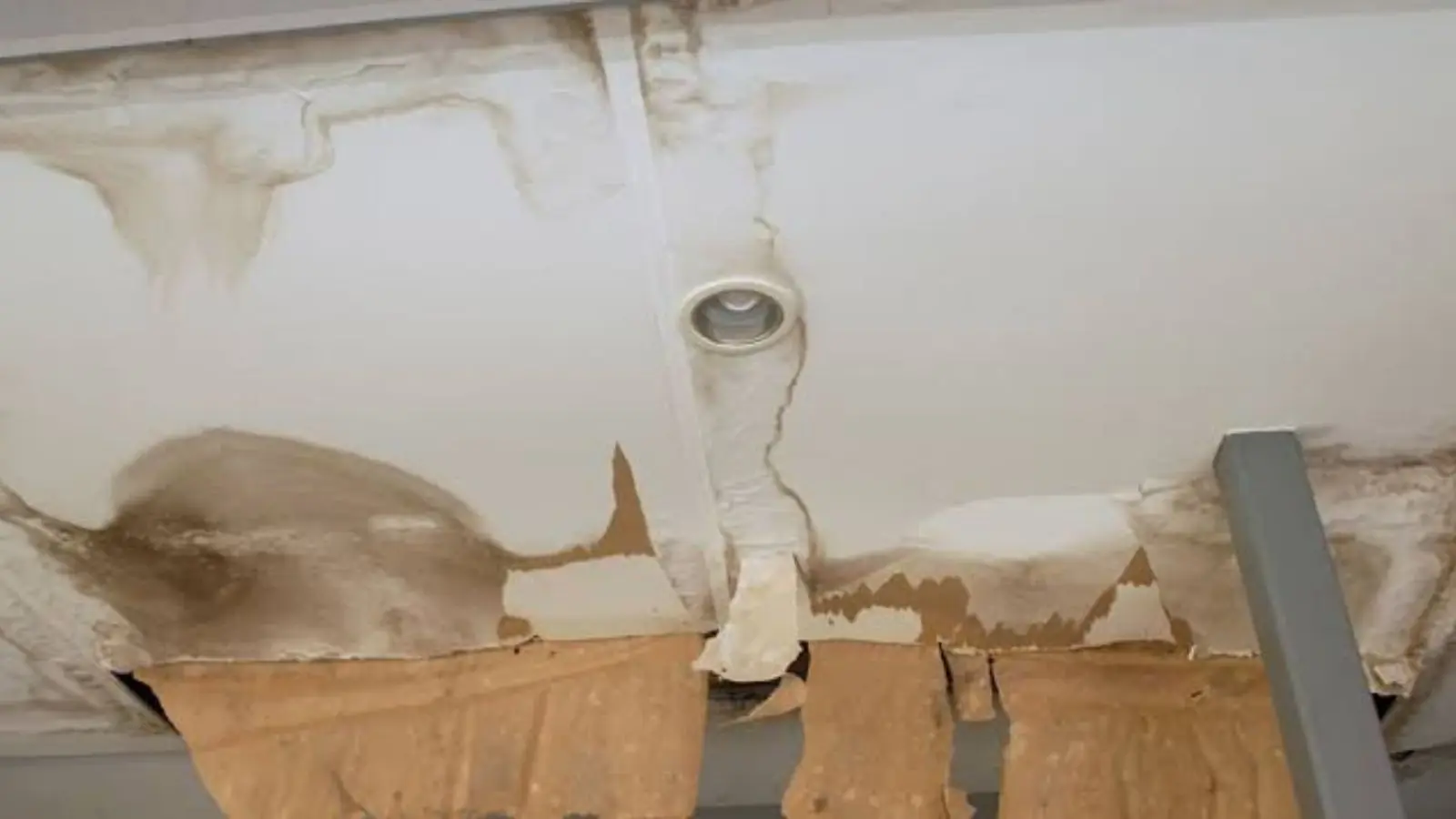 Water stained ceiling with bubbling paint around a light fixture