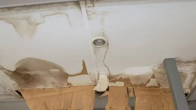 Water stained ceiling with bubbling paint around a light fixture